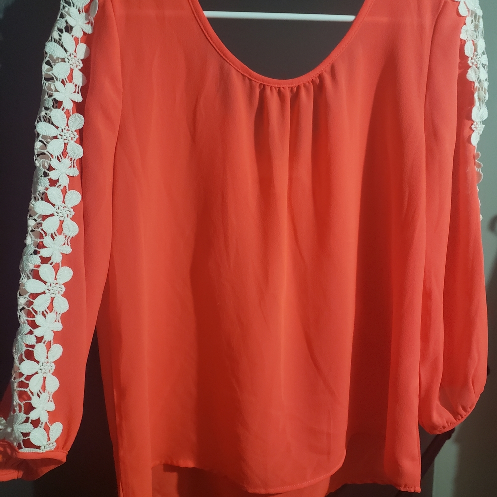 10. 'My Michelle' Vibrant Coral Blouse with White Lace Detail